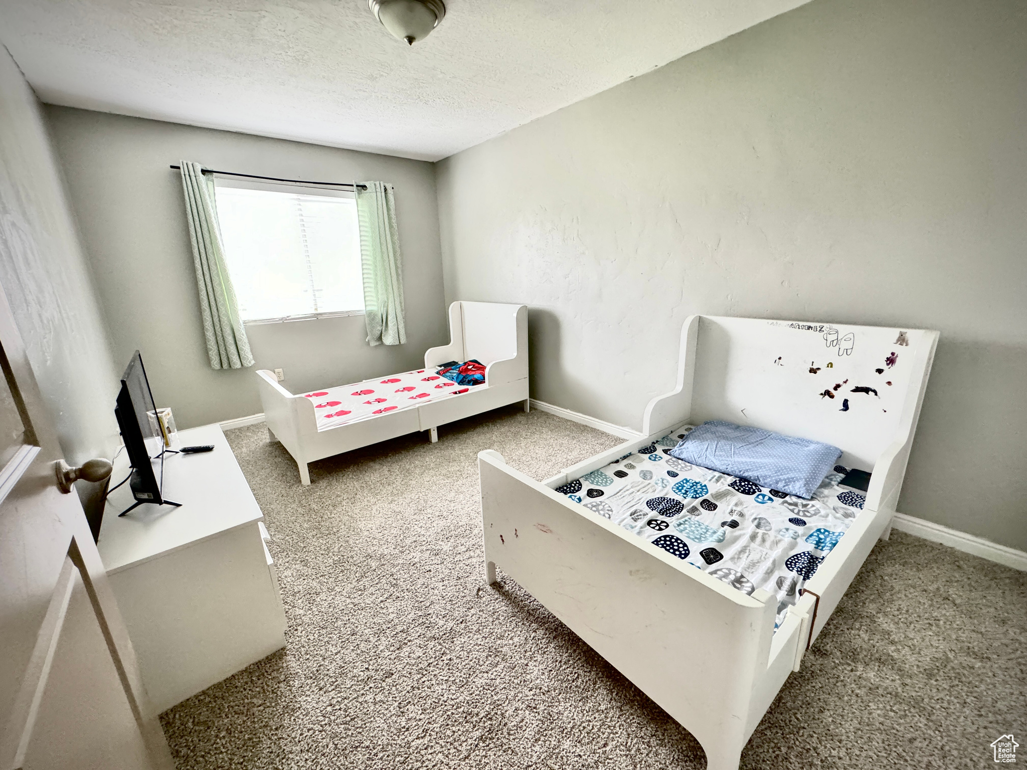 Bedroom featuring carpet flooring and a textured ceiling