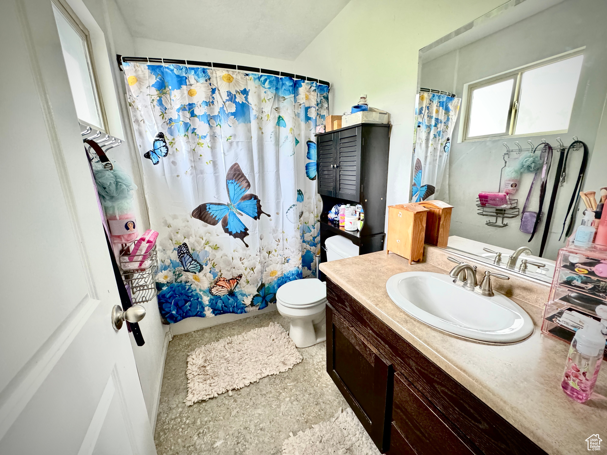 Bathroom with tile floors, large vanity, and toilet