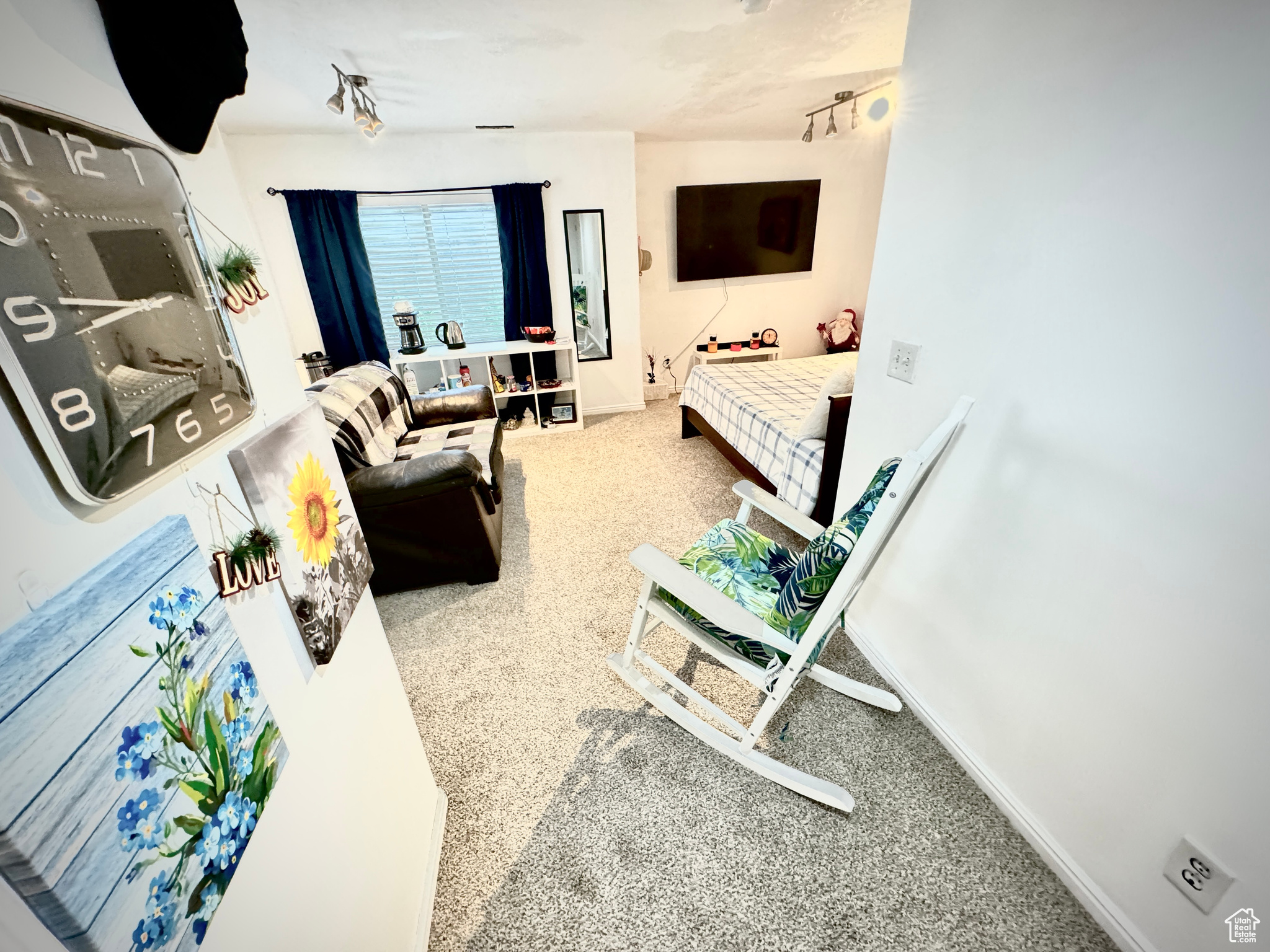 Carpeted bedroom with rail lighting