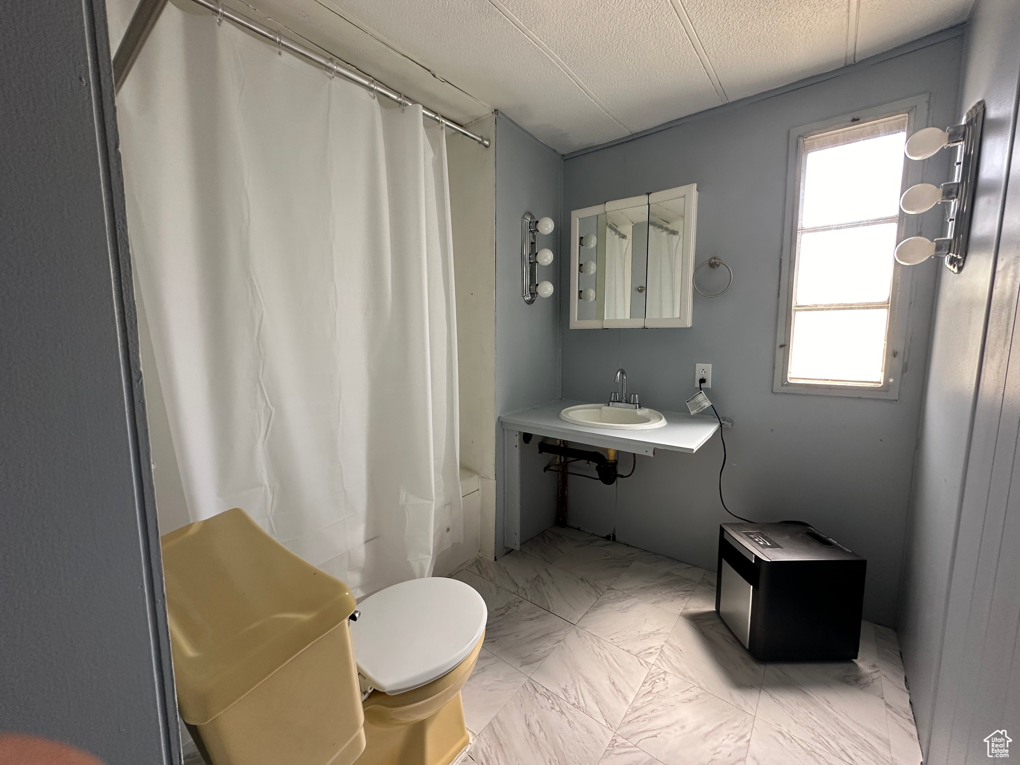 Full bathroom featuring tile floors, shower / tub combo, toilet, and vanity