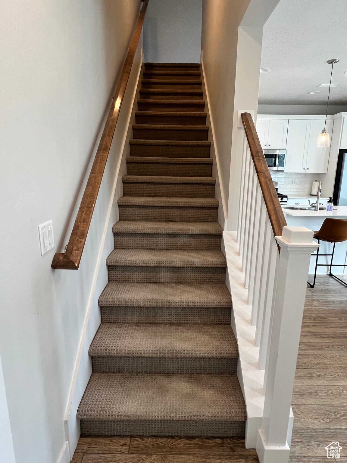 Stairway with hardwood / wood-style flooring