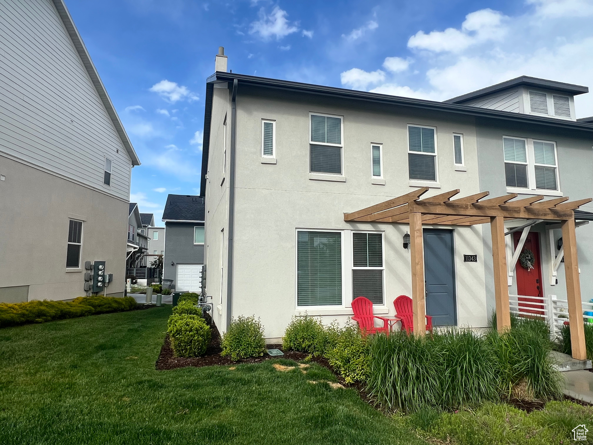 View of front of property with a front yard and a pergola