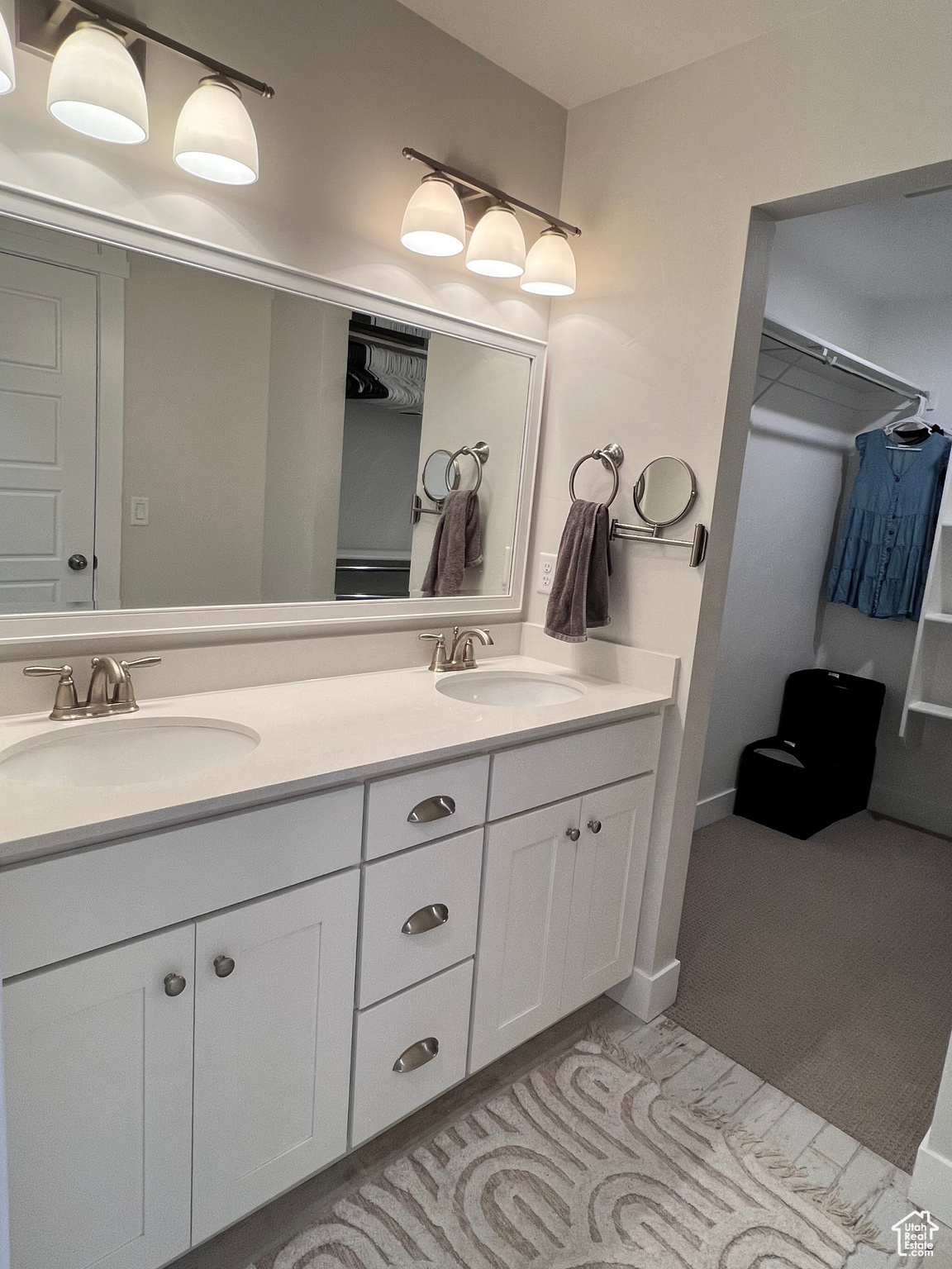 Main bathroom with dual sinks and vanity with extensive cabinet space