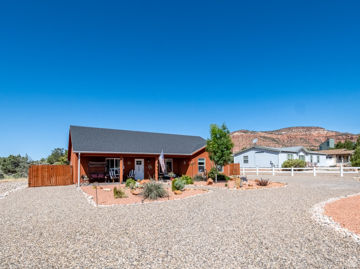 Back of property with a mountain view