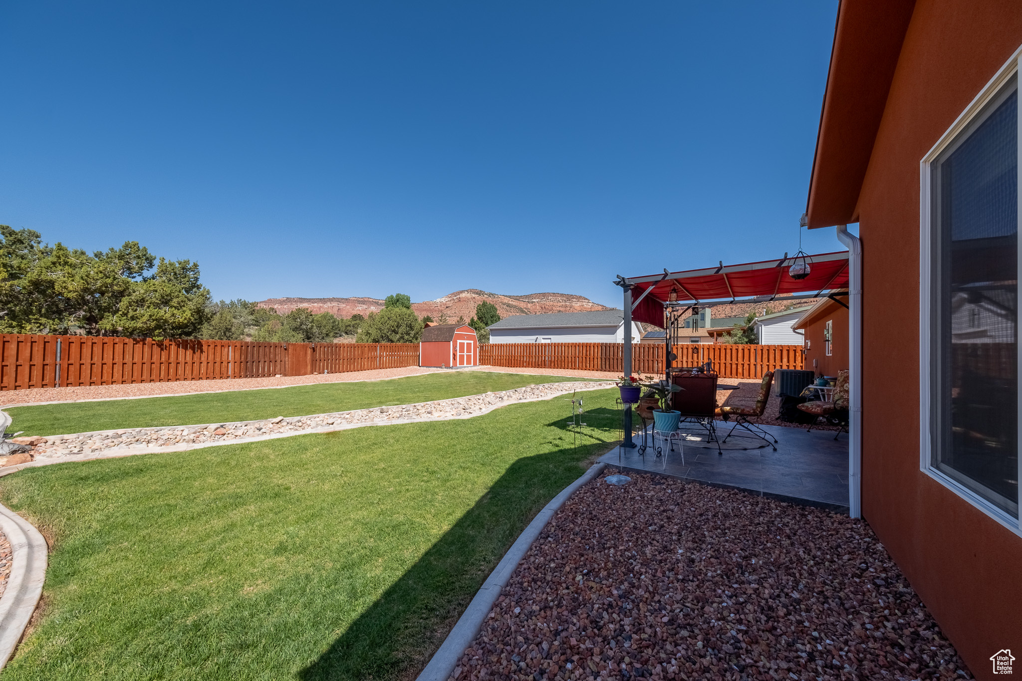 View of yard featuring a storage shed, a patio area, and a mountain view