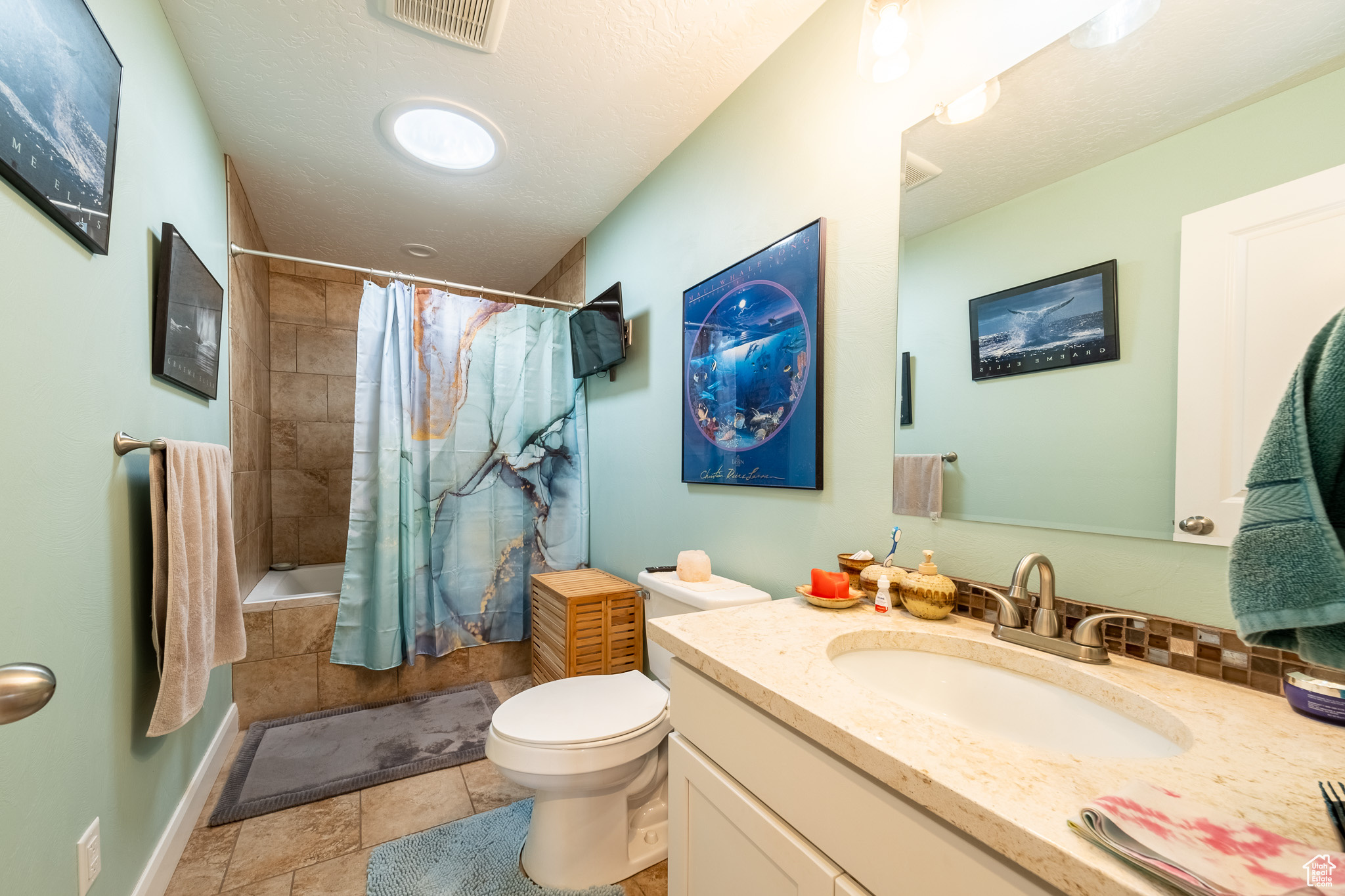 Bathroom featuring tile flooring, vanity, and toilet