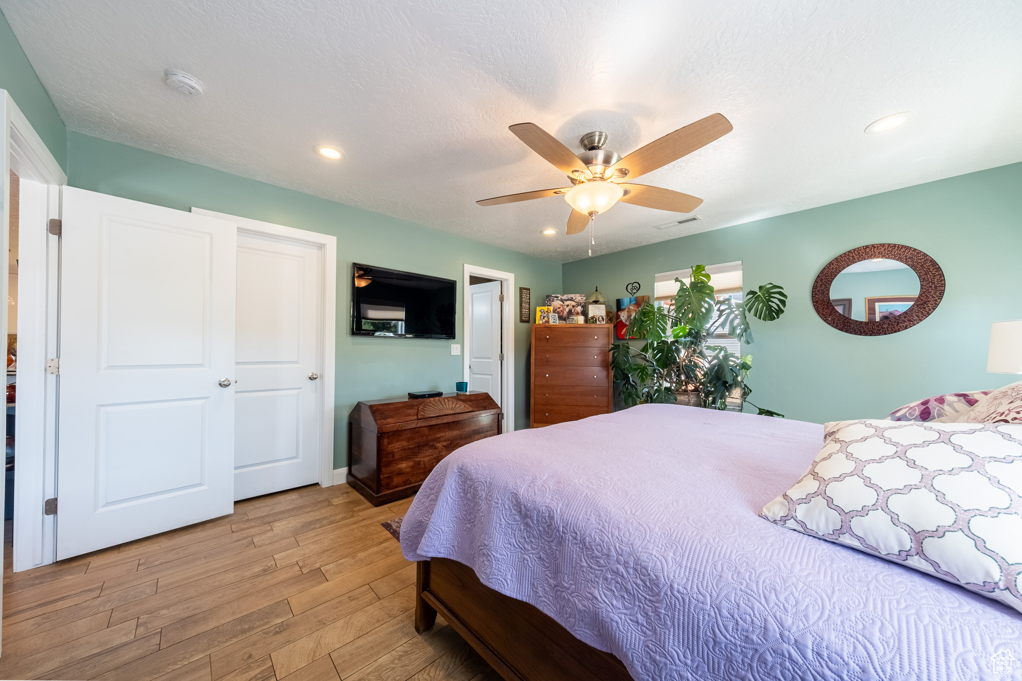 Bedroom with ceiling fan and hardwood / wood-style floors