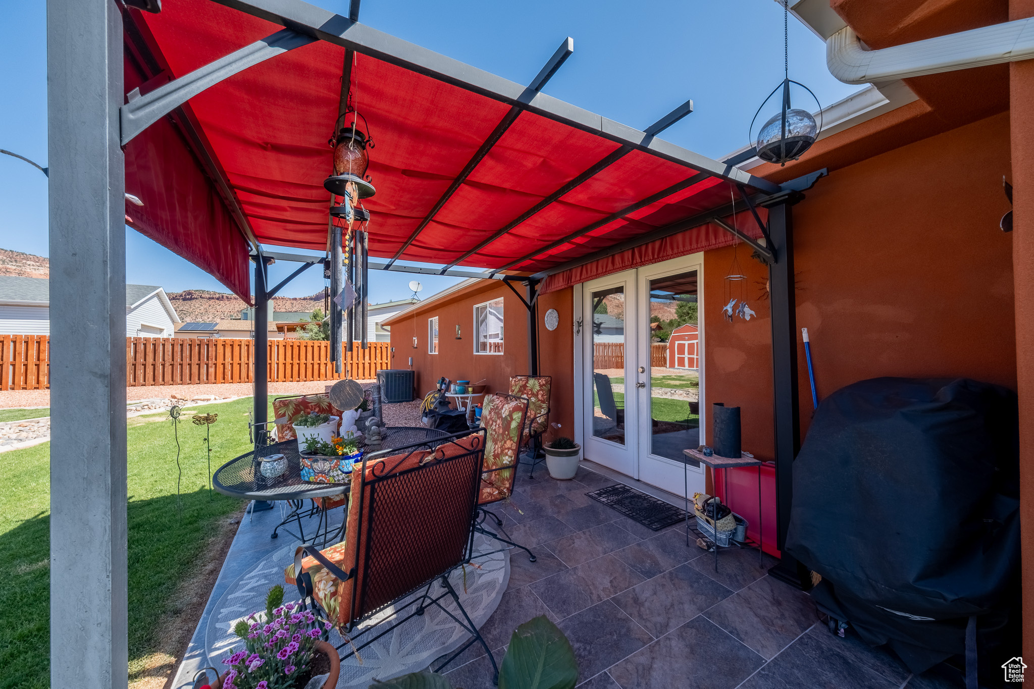 View of terrace with a pergola and french doors