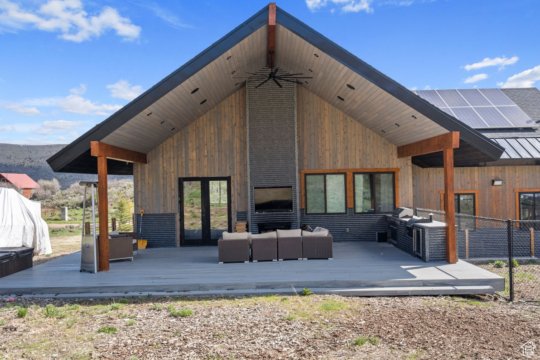 Back of house featuring outdoor lounge area and a wooden deck