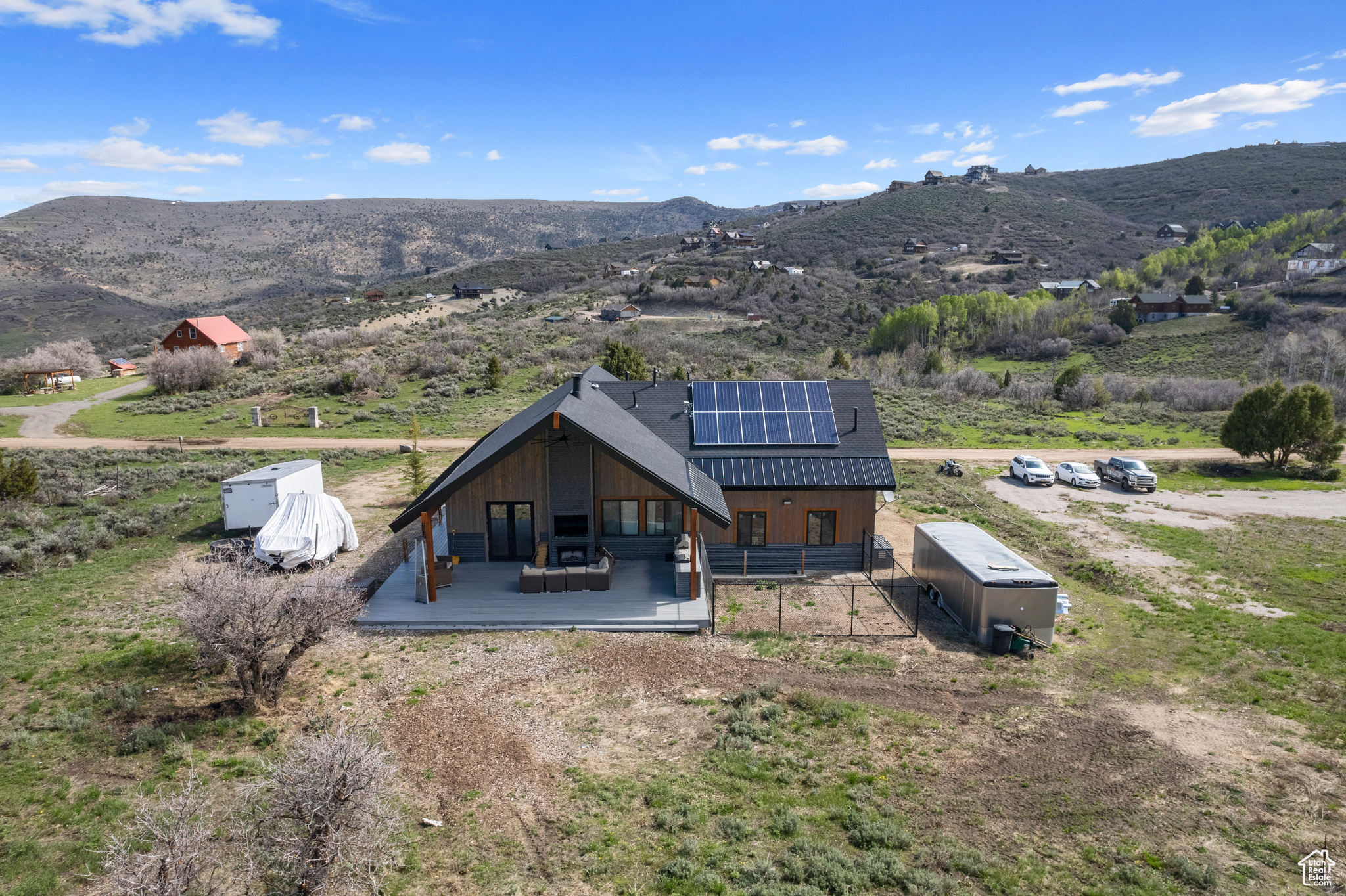 Rear view of house with a mountain view, and solar panels