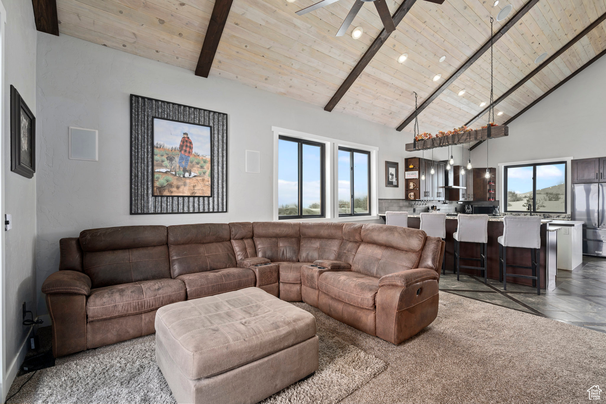 Tiled living room featuring high vaulted ceiling, ceiling fan, wood ceiling, and beam ceiling