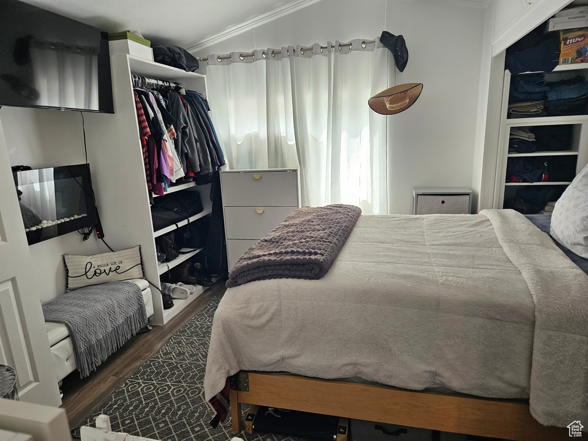 Bedroom with dark hardwood / wood-style floors and crown molding