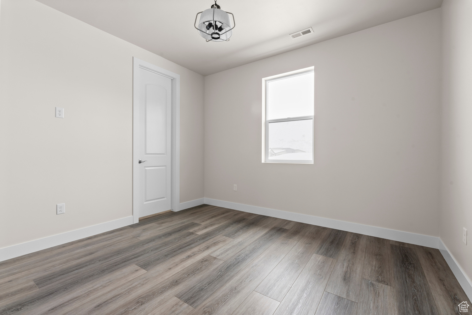 Spare room featuring hardwood / wood-style flooring