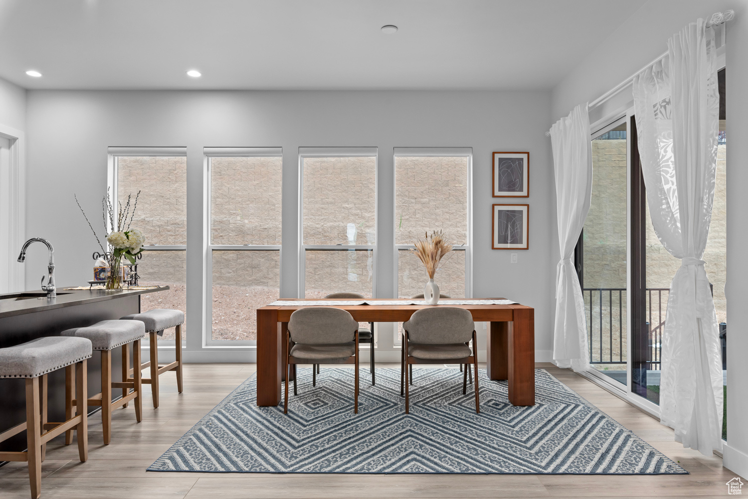 Dining area with sink and light hardwood / wood-style flooring