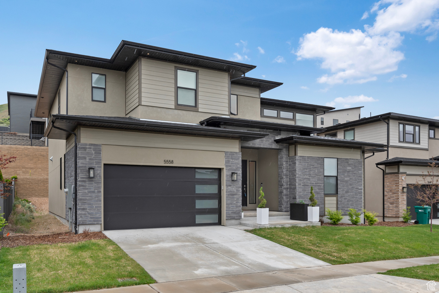 Prairie-style house featuring a garage and a front yard