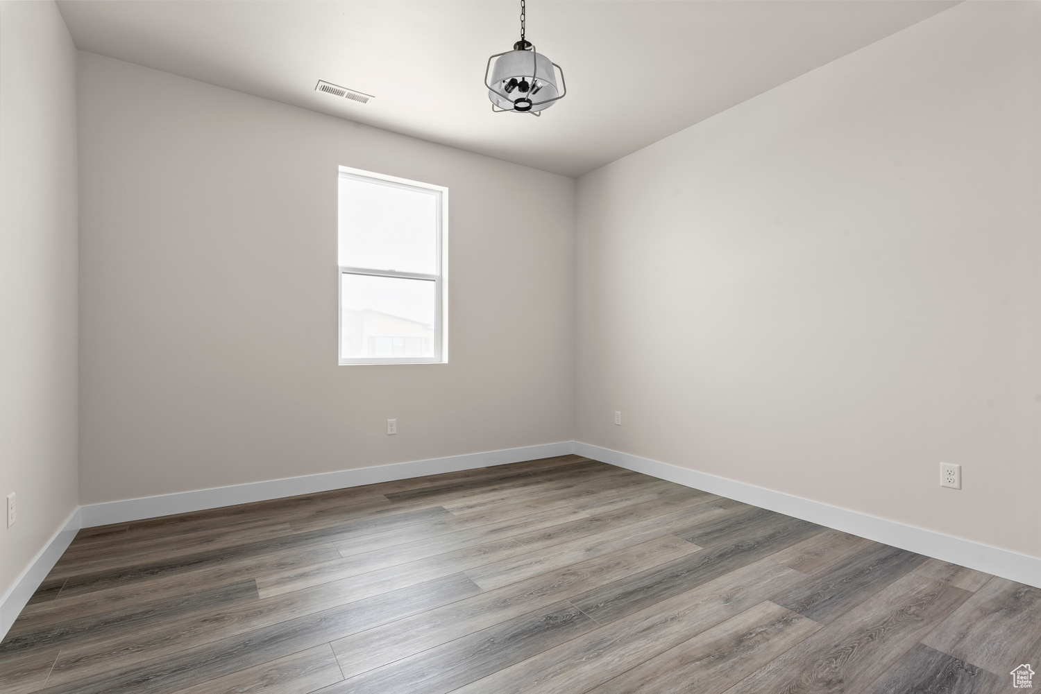 Spare room featuring wood-type flooring