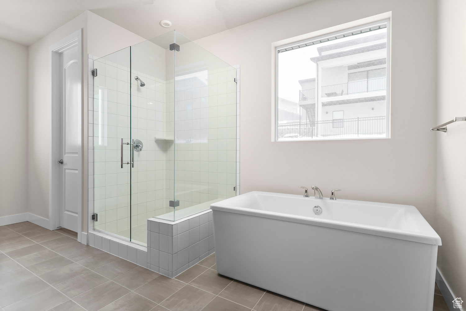 Bathroom with tile flooring and independent shower and bath