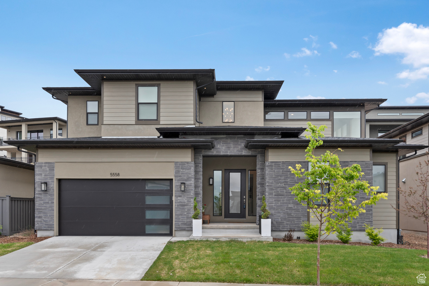 Prairie-style home with a garage and a front yard