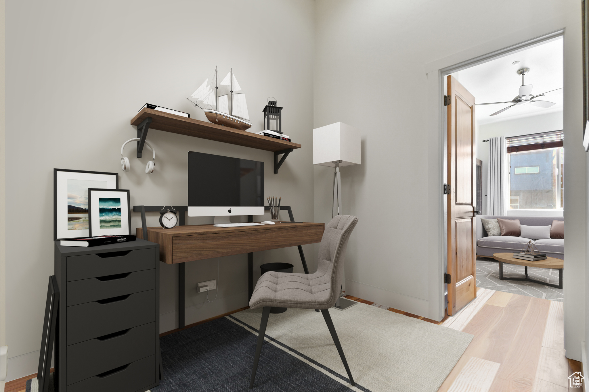 Home office with hardwood / wood-style floors and ceiling fan