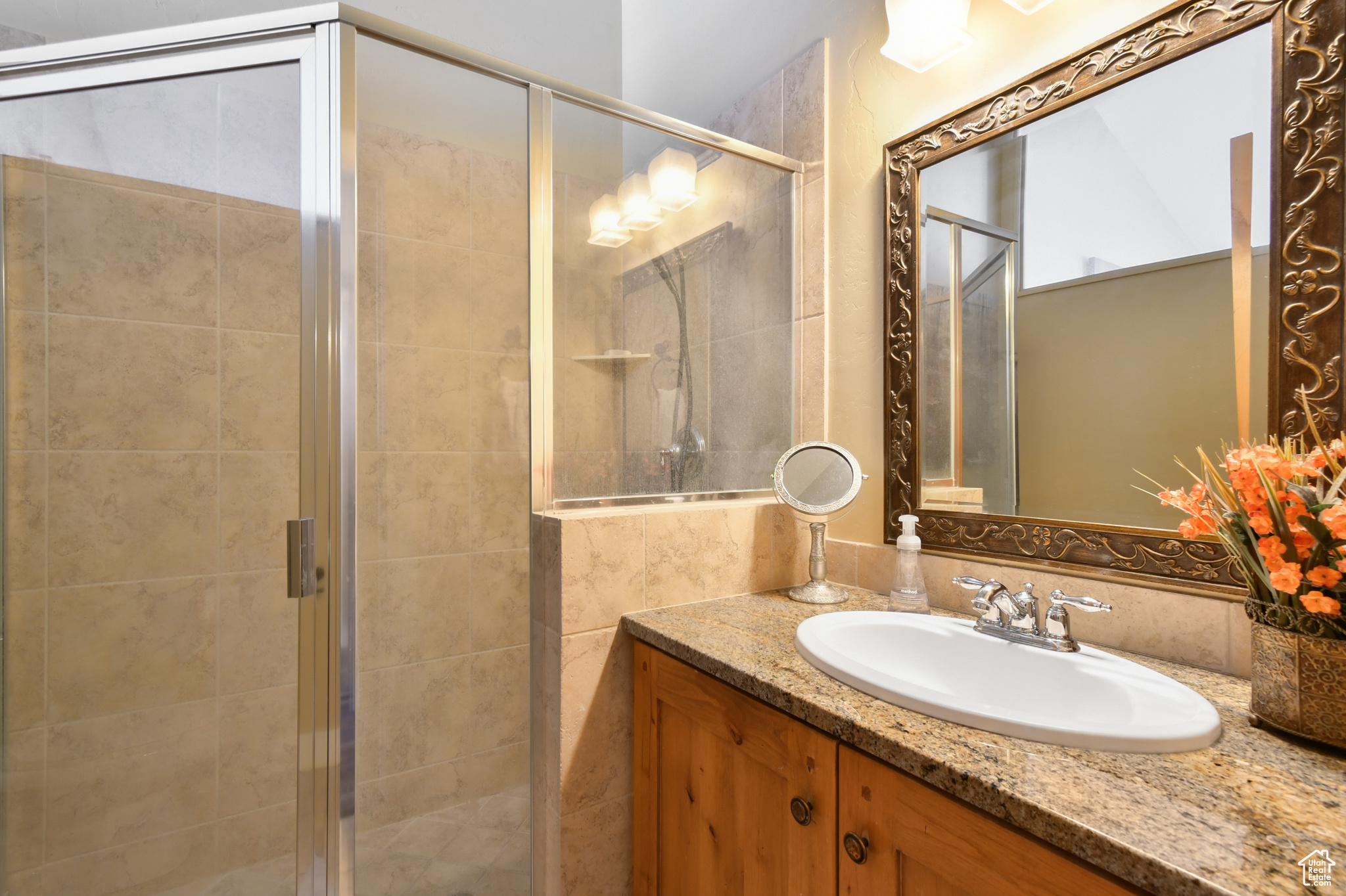 Bathroom featuring walk in shower and vanity