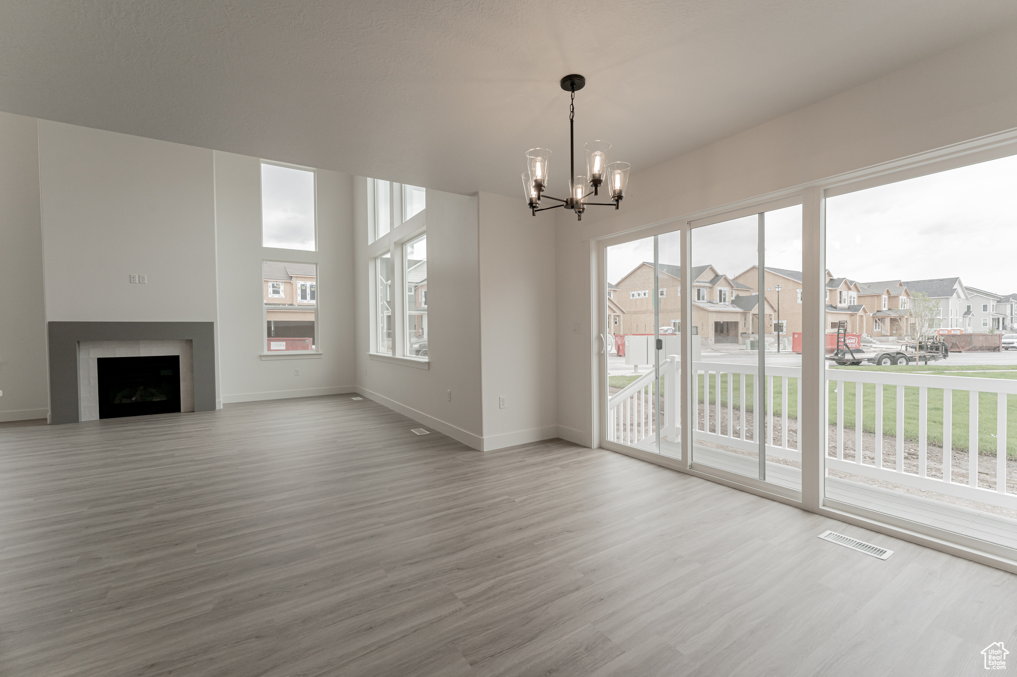 Unfurnished living room with a chandelier and hardwood / wood-style flooring