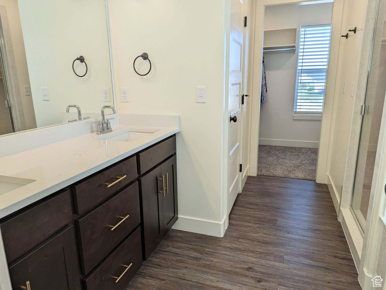 Bathroom featuring hardwood / wood-style floors and dual vanity