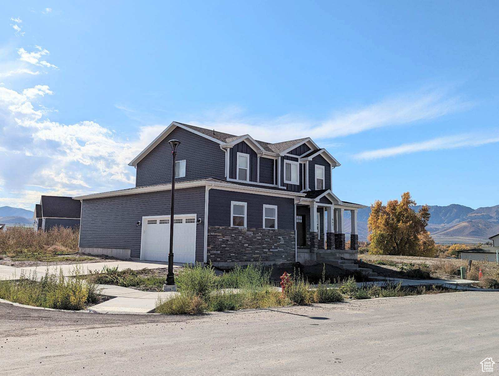 View of front of house with a garage and a mountain view