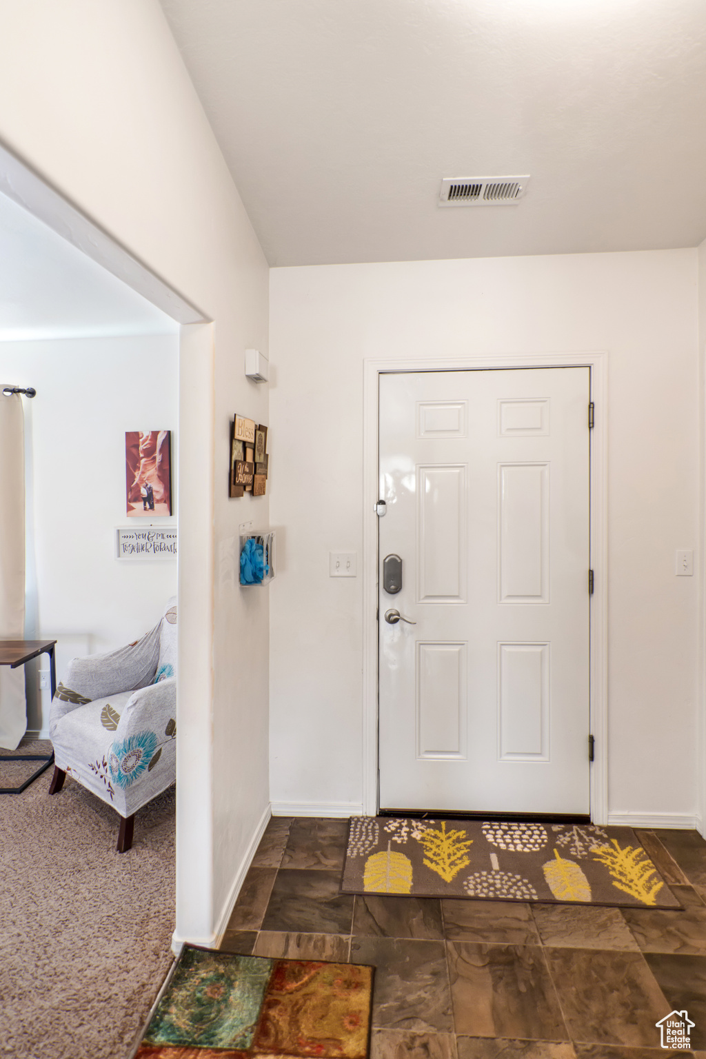 Entryway featuring dark carpet