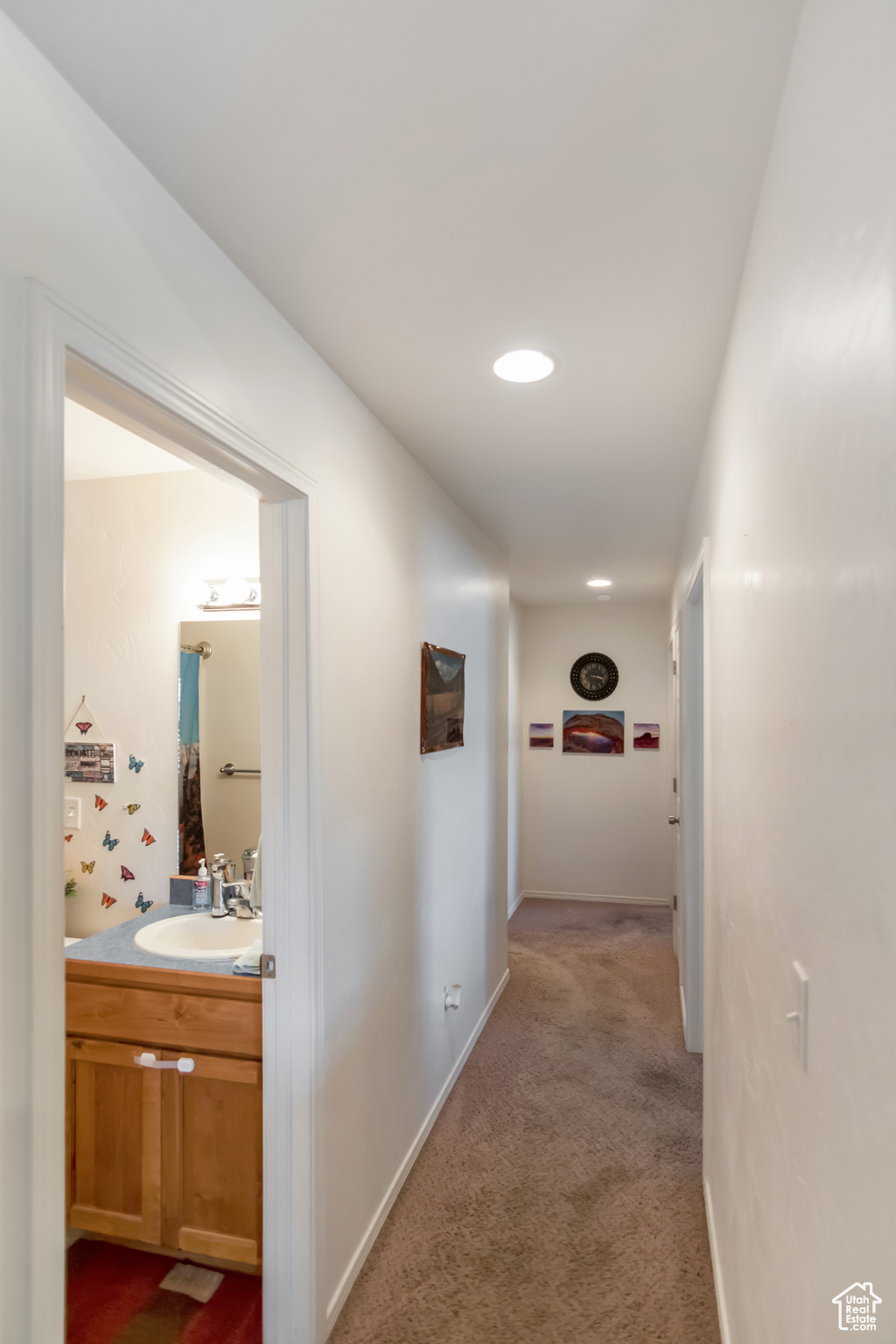 Hallway with carpet flooring and sink