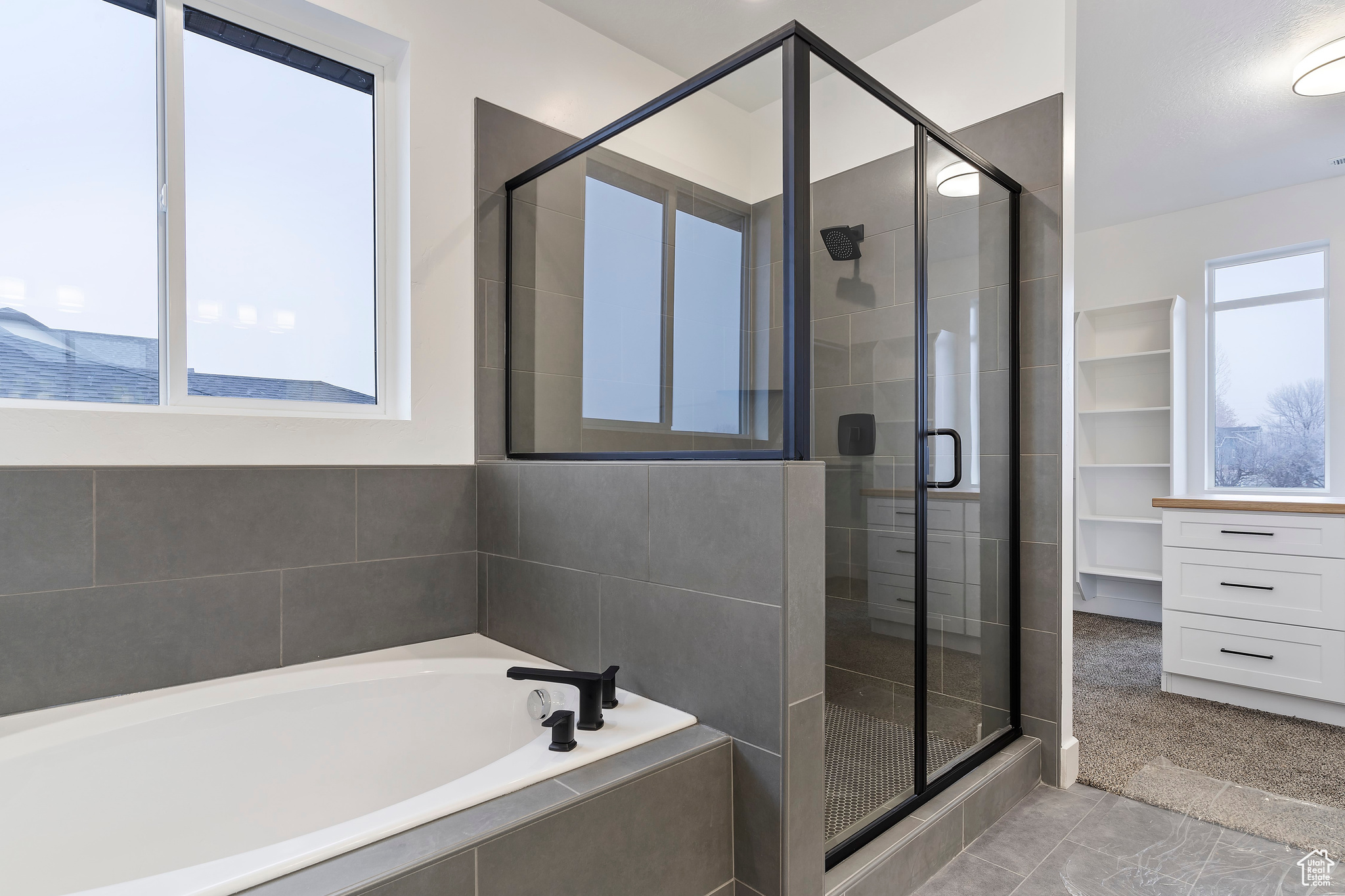 Bathroom with tile floors and plus walk in shower