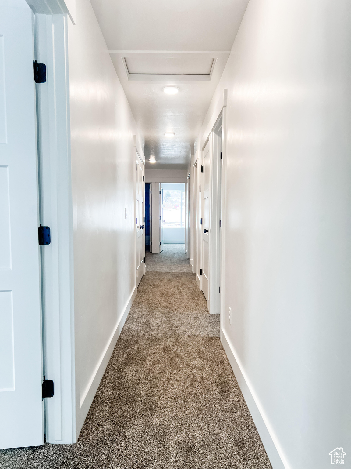 Hallway with carpet flooring