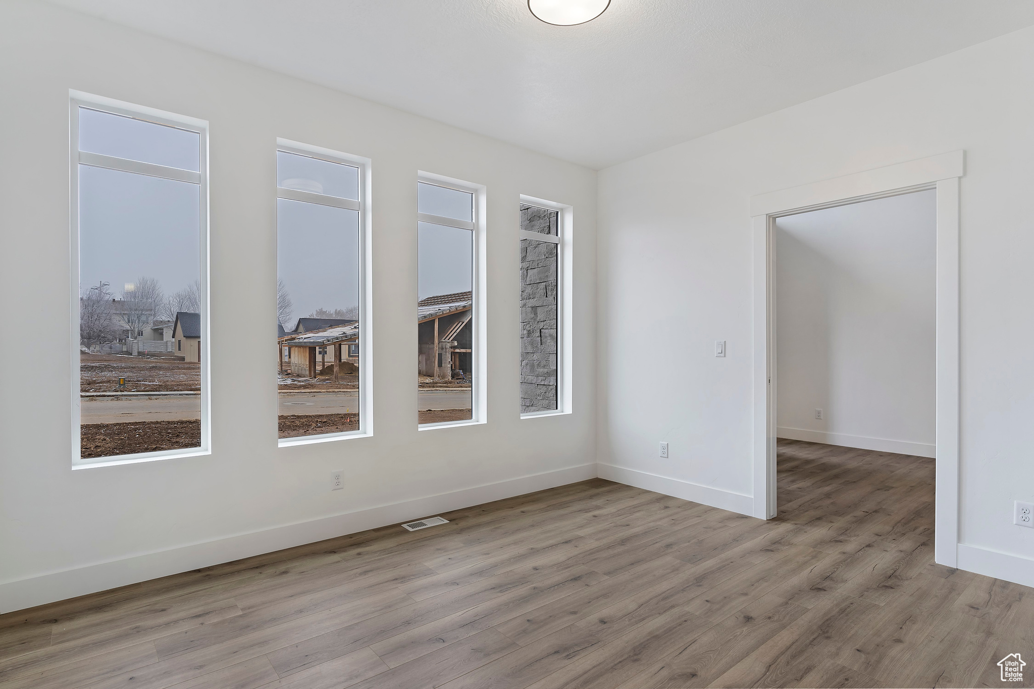 Spare room featuring hardwood / wood-style floors and a wealth of natural light