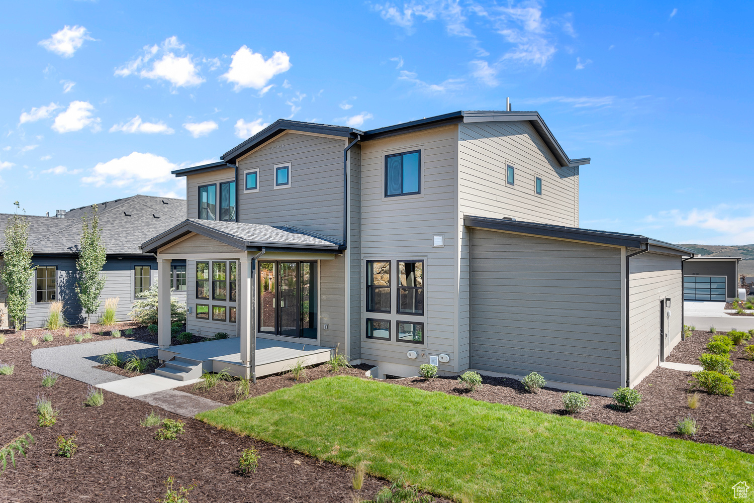 Rear view of house with a lawn and a patio area