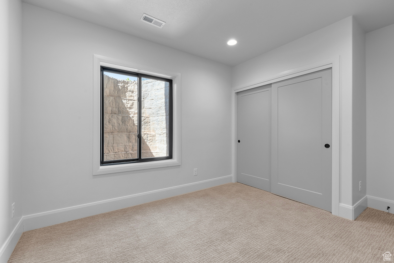 Unfurnished bedroom featuring a closet and carpet