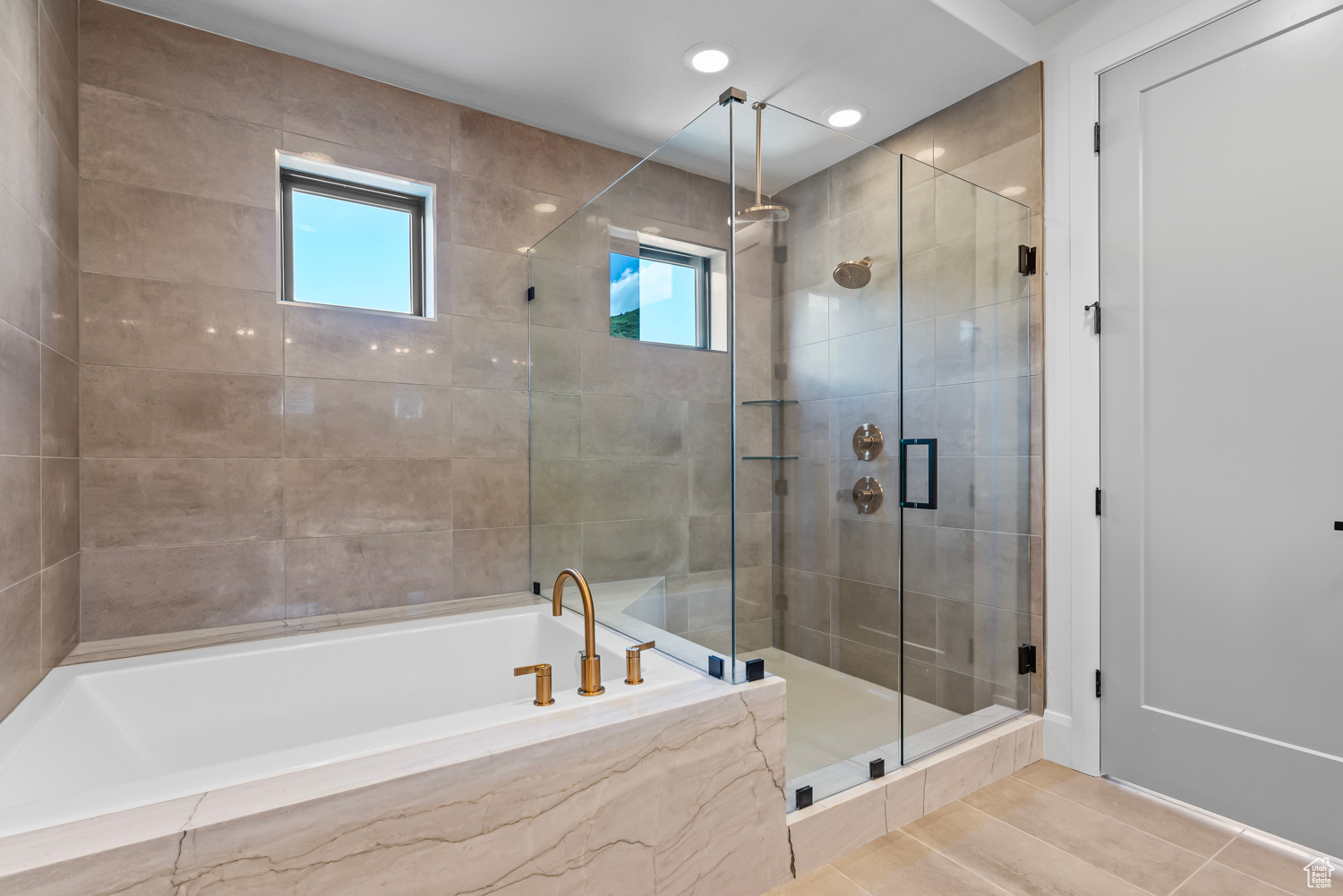 Bathroom featuring shower with separate bathtub and tile patterned floors