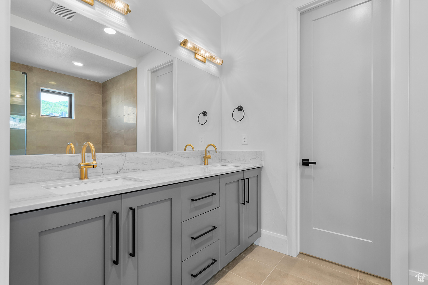 Bathroom with tile patterned flooring and vanity