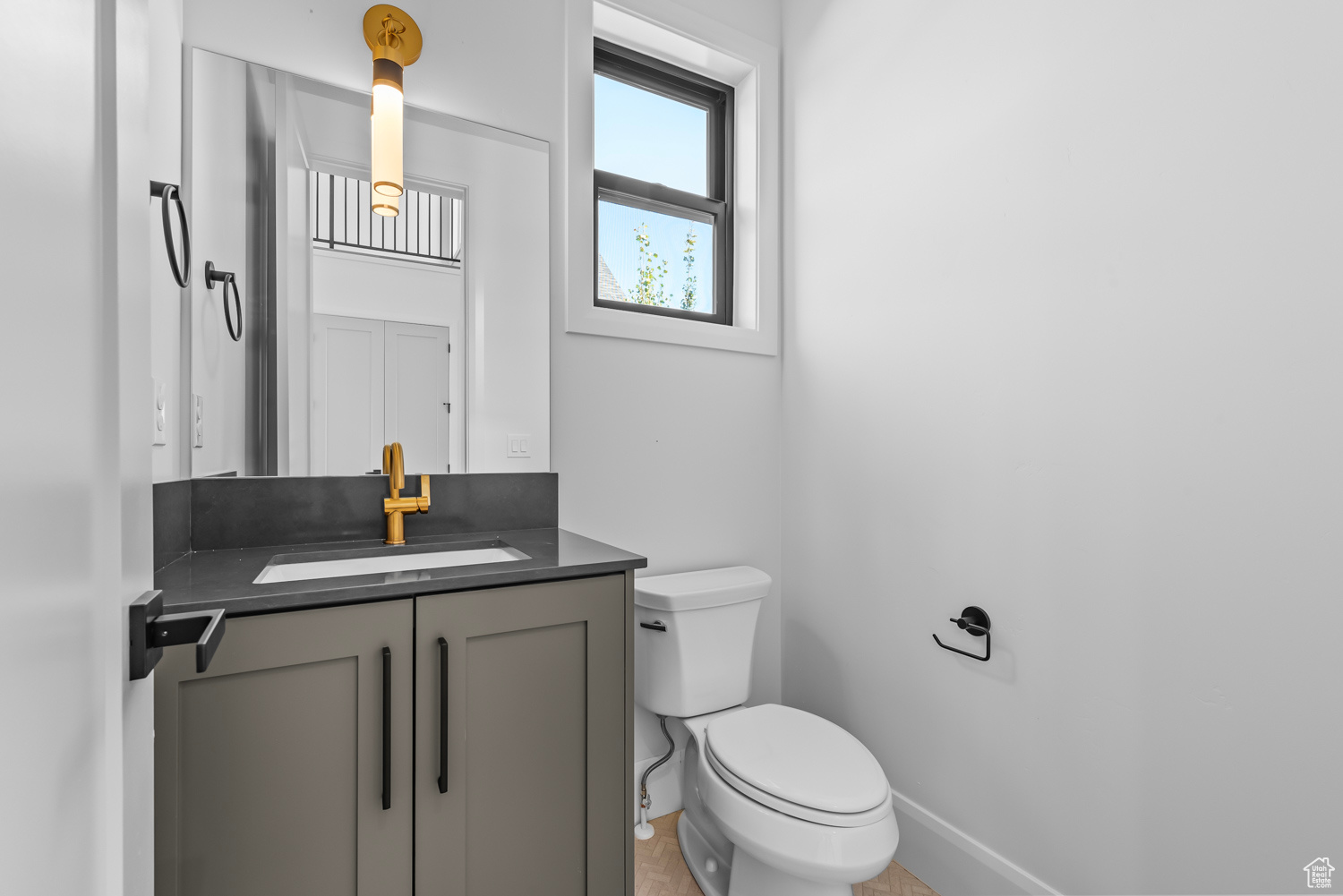 Bathroom featuring tile patterned flooring, toilet, and vanity