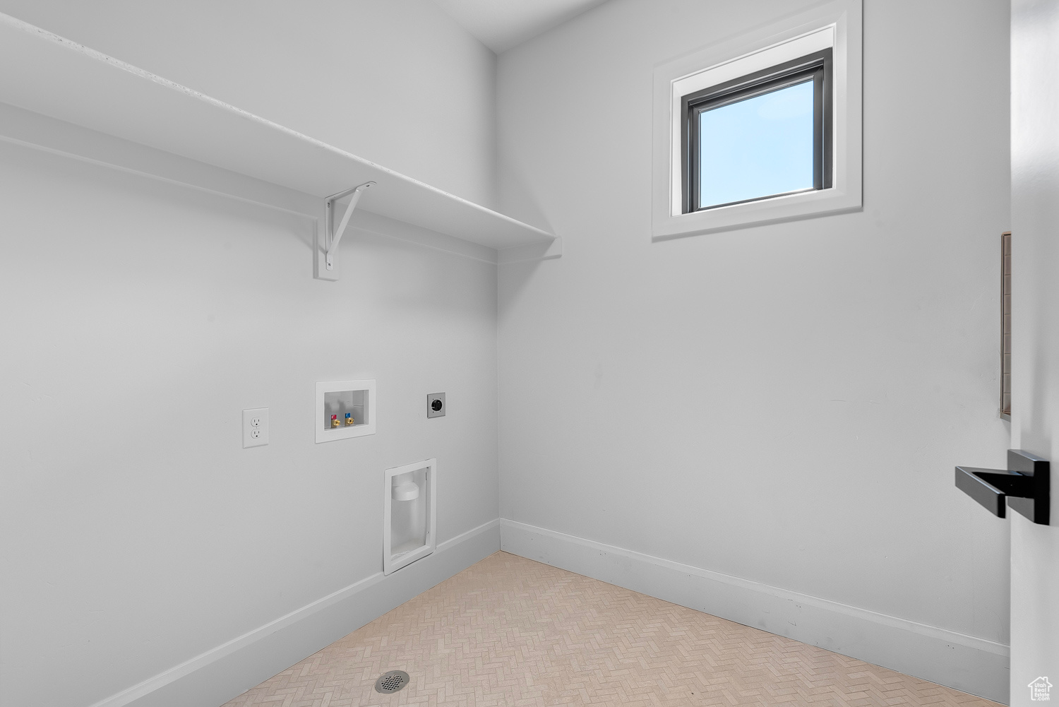 Laundry room with light tile patterned floors, hookup for a washing machine, and hookup for an electric dryer