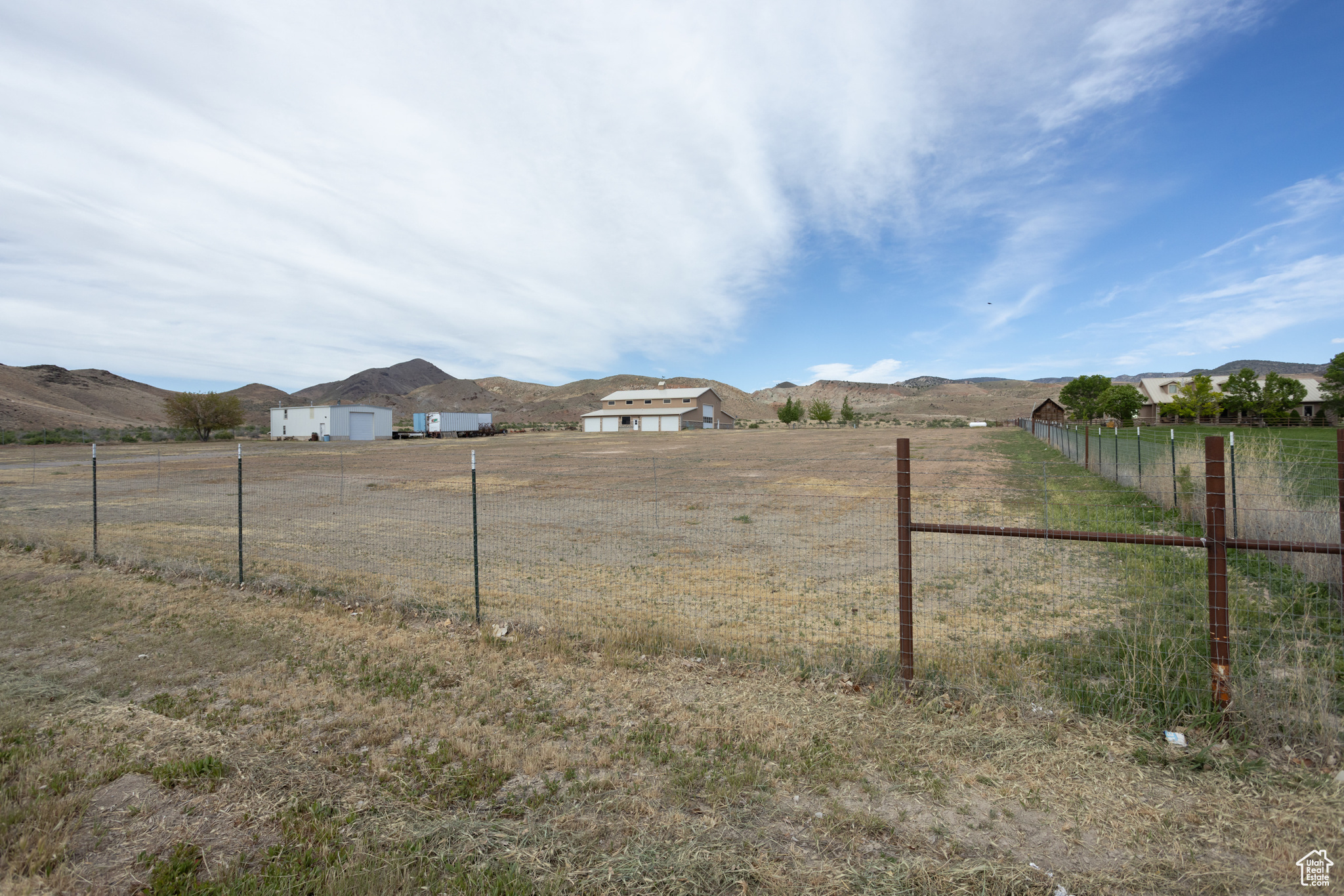 View of yard with a rural view, a garage, and a mountain view