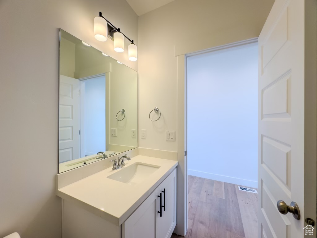 Bathroom featuring vanity and hardwood / wood-style flooring