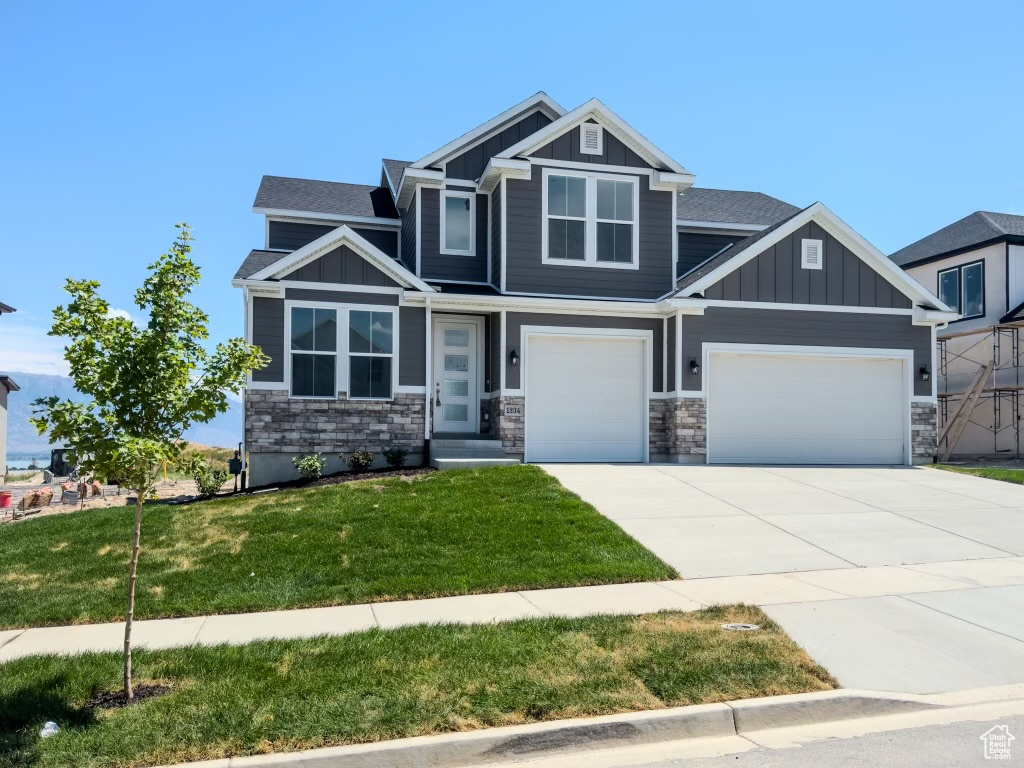 Craftsman-style home featuring a front lawn