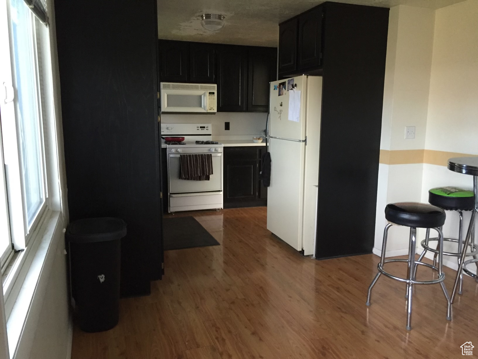 Kitchen featuring white appliances and wood-type flooring