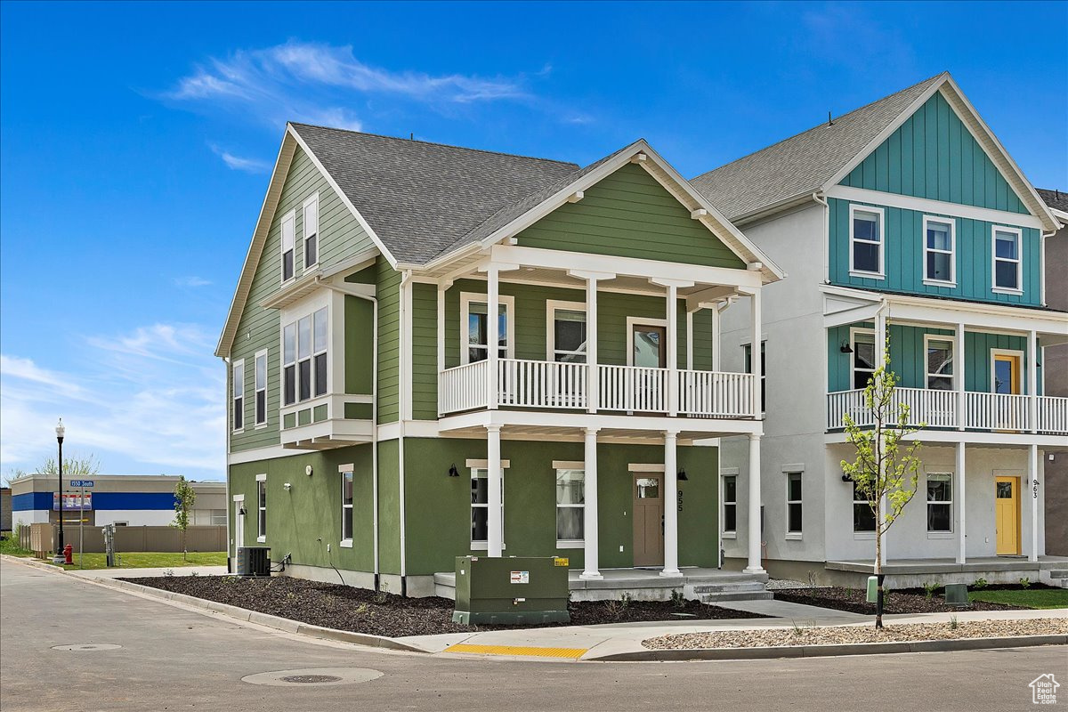 View of front of home featuring central AC and a balcony