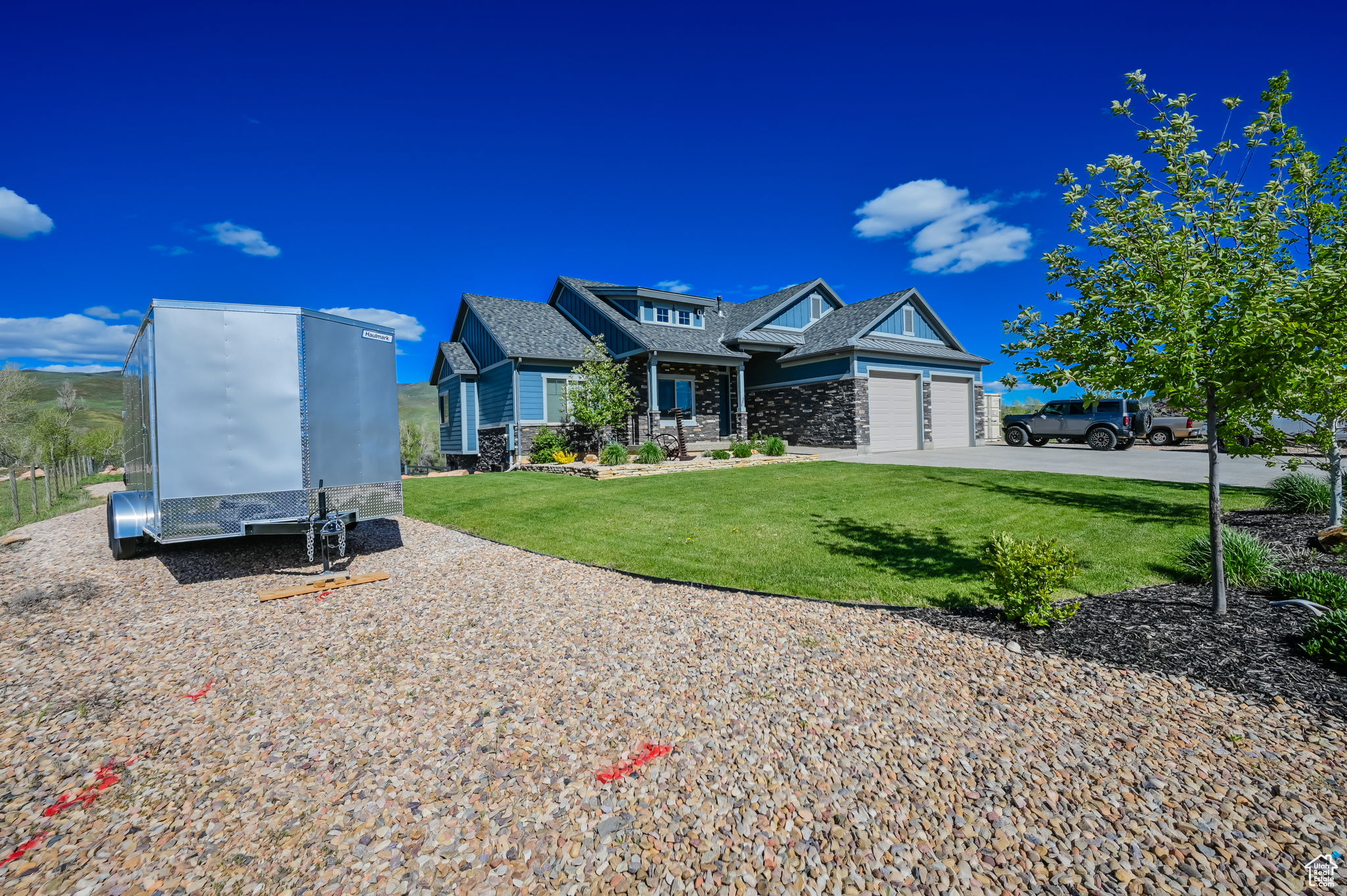 View of front of property featuring a front yard and a garage