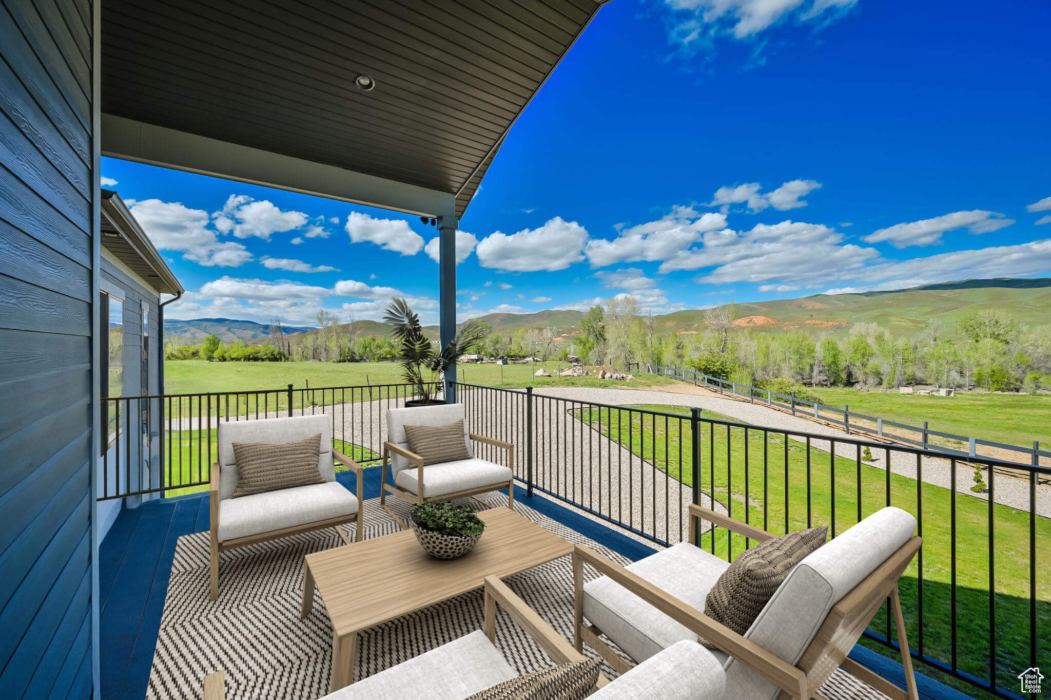 Deck with a mountain view and a lawn