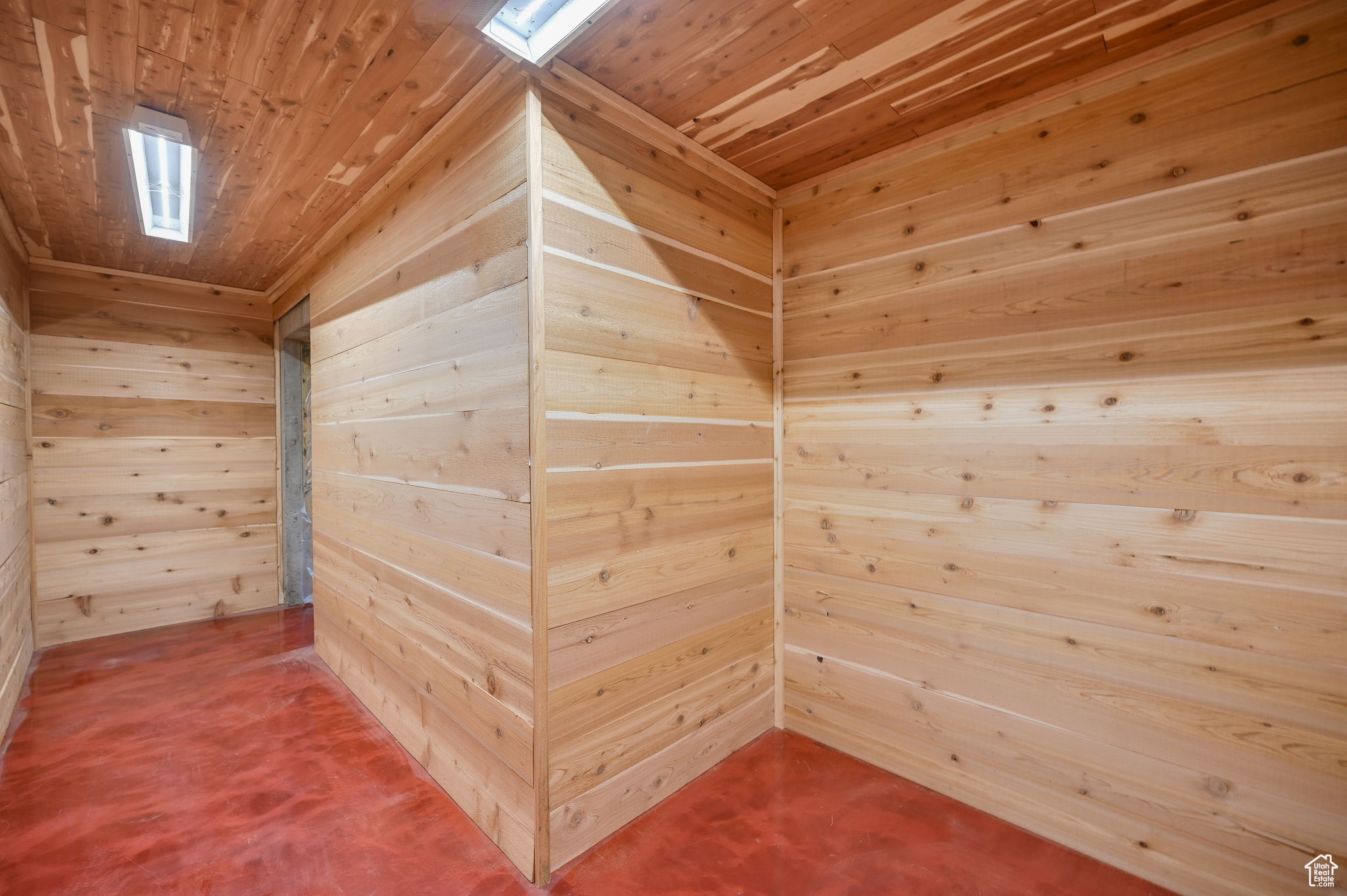 View of sauna with wooden ceiling and wood walls