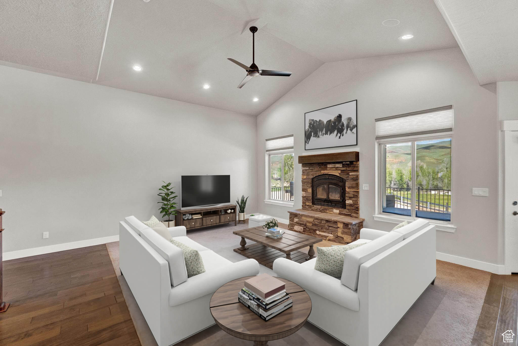 Living room featuring high vaulted ceiling, hardwood / wood-style flooring, a fireplace, and ceiling fan