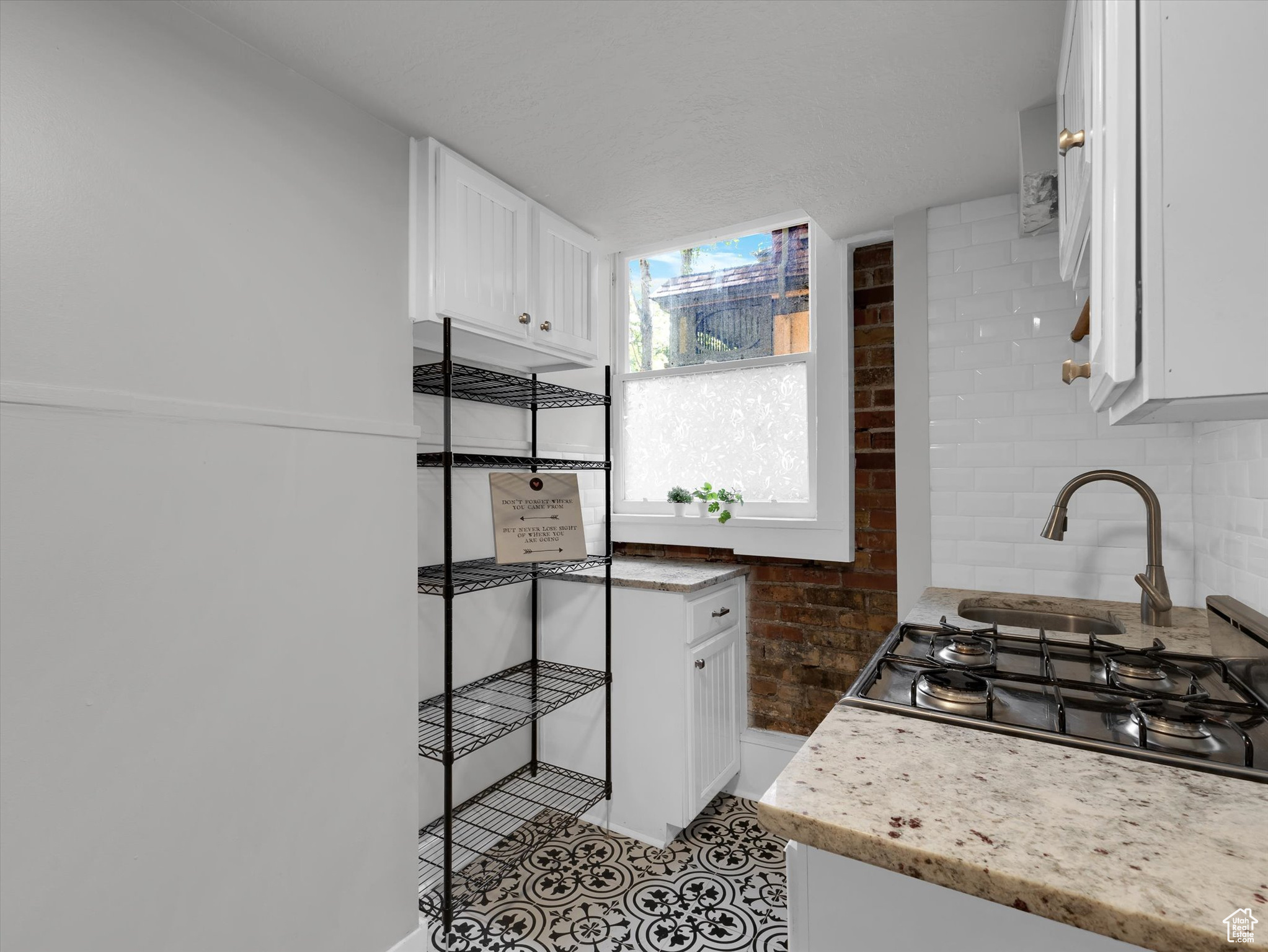 Kitchen with stove, oven, and shelving