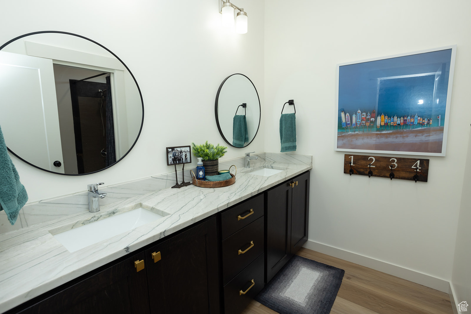 Bathroom featuring large vanity, hardwood / wood-style flooring, and double sink