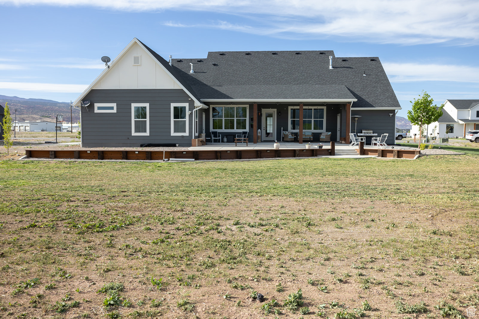 Back of house with a yard